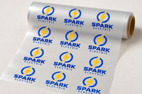 Roll of DTF transfer film printed with a repeating business logo gang sheet